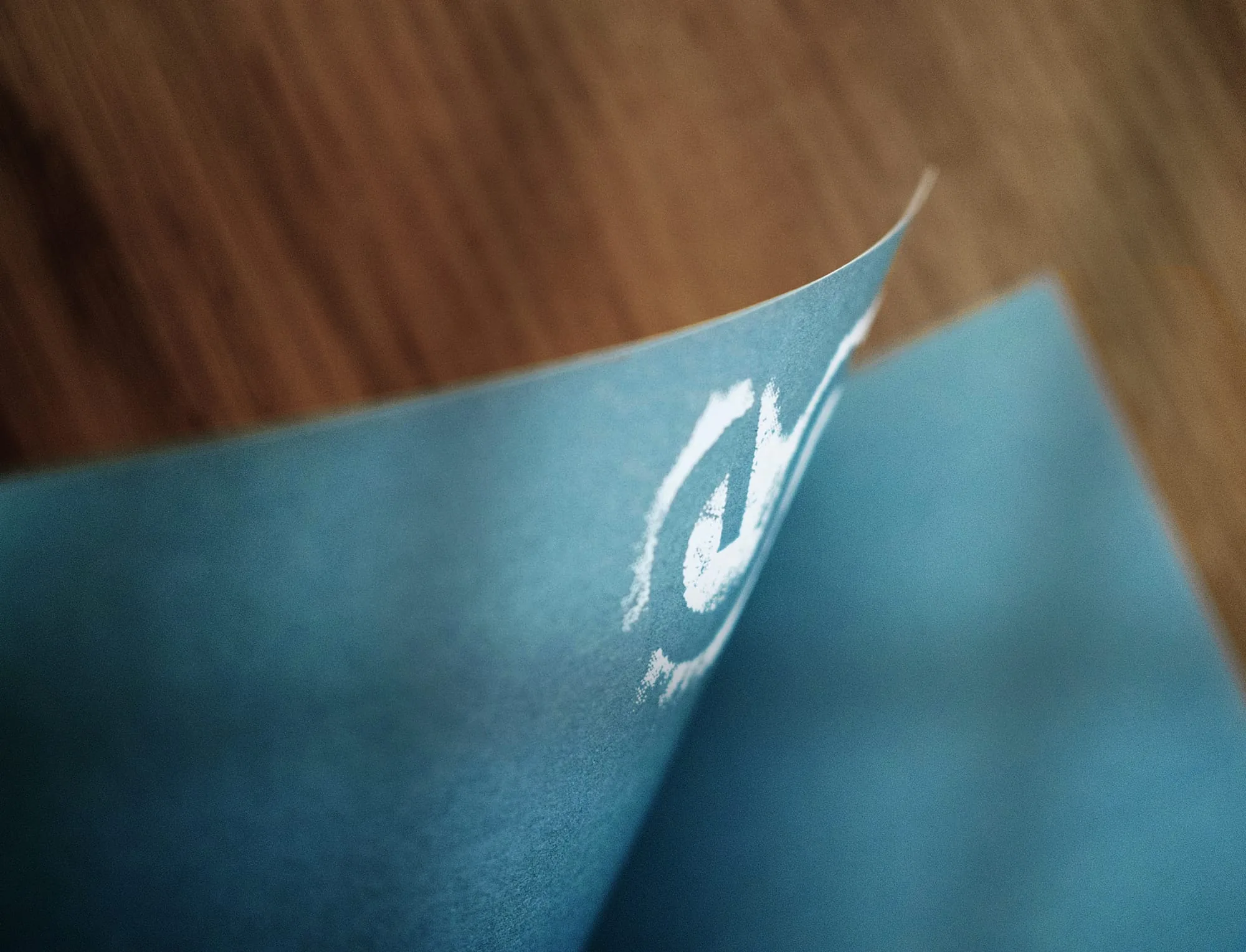 sg_letter_closeup_2026 Partial view of a blue letterhead with a white S shaped logo, curling at the edge.